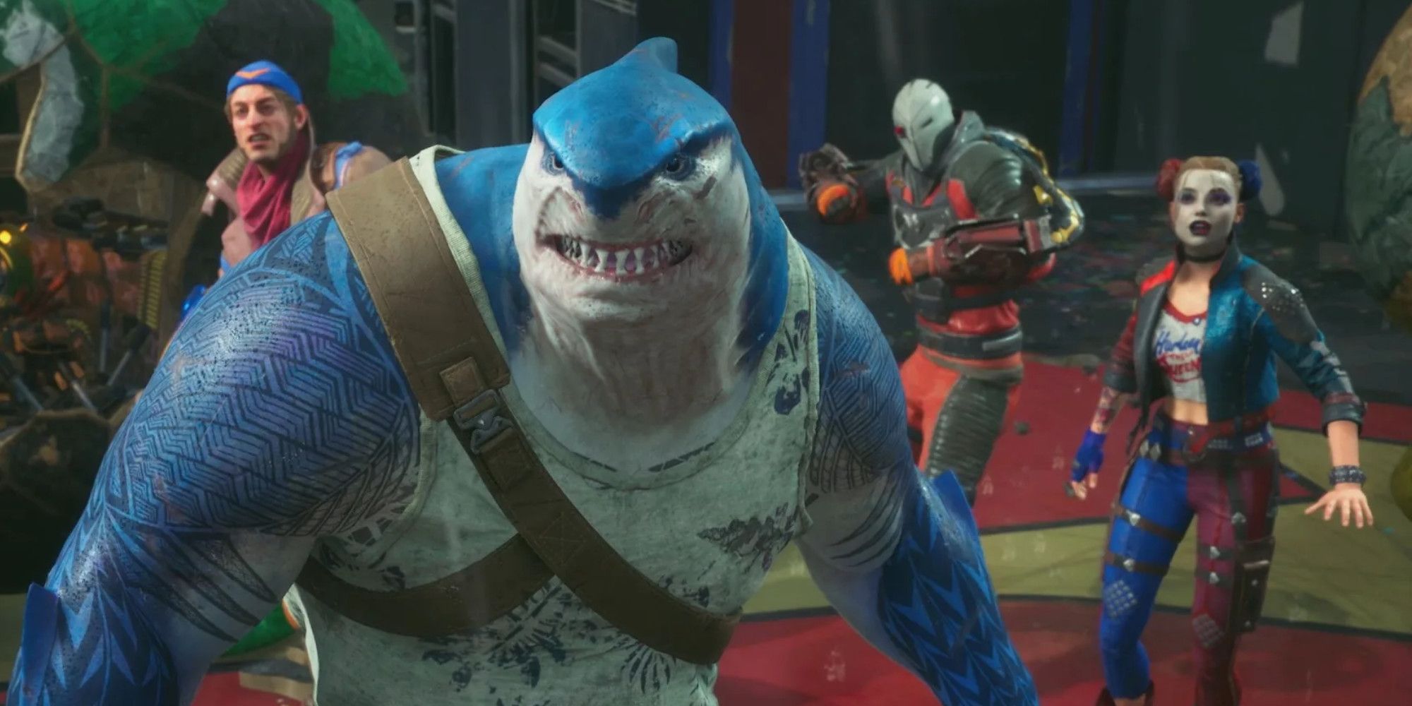 King Shark y los demás miembros del Escuadrón Suicida al fondo.