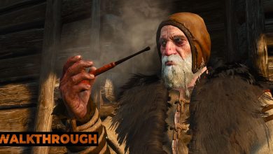 An old man smokes a pipe with his wooden hut behind him on a sunny day.