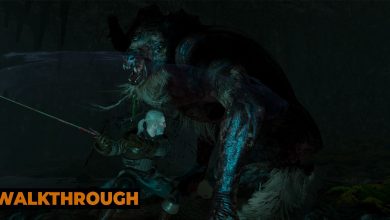 Geralt fights a chort in a dark cave, swinging his sword in a bid to kill it.
