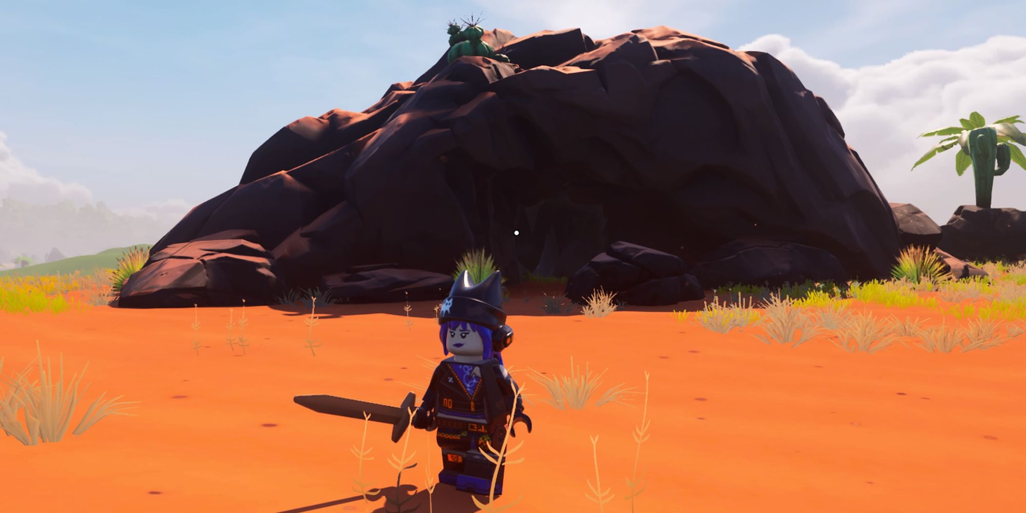 Un jugador frente a una cueva en el bioma del desierto en Lego Fortnite.